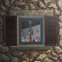 Einblick durch ein erleuchtetes Fenster einer spanischen Finca
